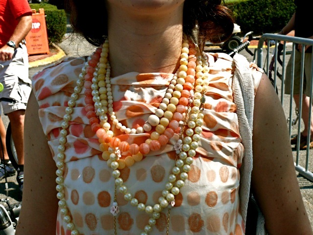 Fashion Stylist Elizabeth Wachstein perfectly paired ropes of pearls citrus glass beads and coral glass beads and ivory colored bobbles against a very pretty vintage dotted drop waist dress