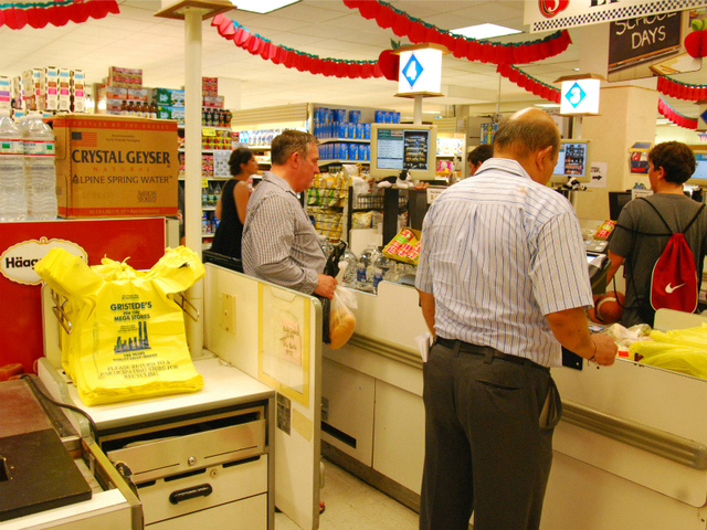 Customers buy bottled water at Gristedes on Friday, Aug. 26, 2011, stocking up for a possible hurricane. 
