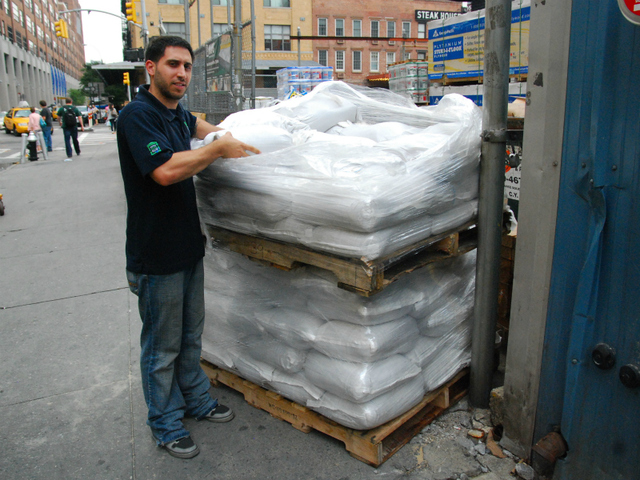 Phil Dean, at Prince Lumber in Chelsea, loads sandbags off onto a skid on Aug. 26.