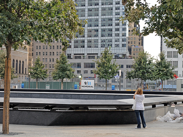 A woman takes a picture of the memorial. 