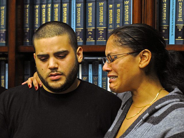 Collado's niece, Banayz Taveras weeps as she puts her arm around John Collado Jr.
