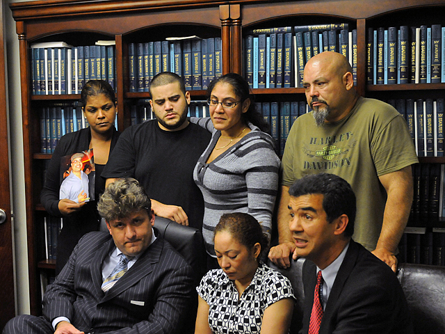 The family of John Collado gathered at their lawyer's Downtown office on Sept. 8.  From left to right in the back row: niece Yajaira Brion, son John Collado, Jr., niece Banayz Taveras, brother Pablo Collado.  Front row, left to right: attorney, Patrick Brackley, Collado's wife, Amarilis Collado and City Councilman Ydanis Rodriguez.