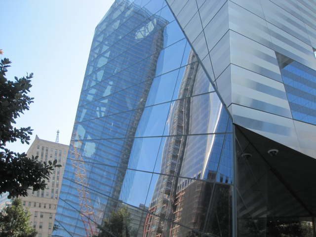 A reflection in the facade of the  still-progressing National September 11 Museum.