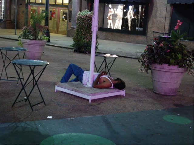 A man sleeps in the plaza space directly in front of Macy's Herald Square, Wed. Sept. 14.