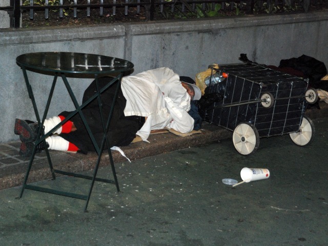 A man sleeps in the plaza space directly in front of Macy's Herald Square, Wed., Sept. 14.