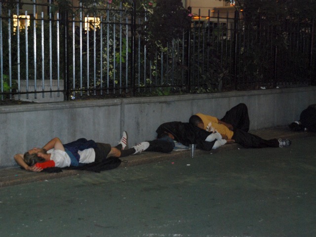 Two people sleep in the plaza space directly in front of Macy's Herald Square, Tuesday, Sept. 13.