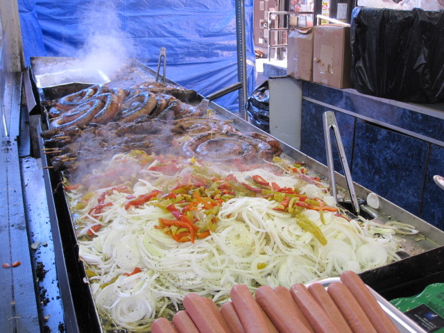 Sausages, onions and peppers cook at the San Gennaro festival on Fri., Sept. 16, 2011.