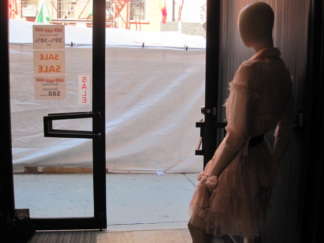 The view from a Mulberry Street boutique is blocked by vendors' tents.