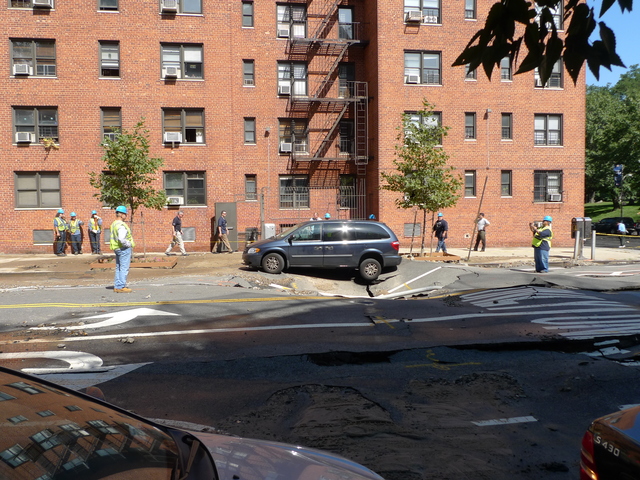 A minivan was towed away so crews could dig up the street and investigate a broken water main.