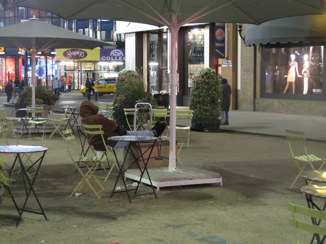 A homeless man asleep in plaza in front of Macy's Herald Square just before midnight on Sunday, Sept. 18.