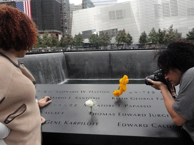 Yesenia L. Rodriguez, 38 (right) and her sister Joannitte Rodriguez, 35, of the Lower East Side pause to remember their childhood friend at the 9/11 Memorial during community day on Oct. 2, 2011.