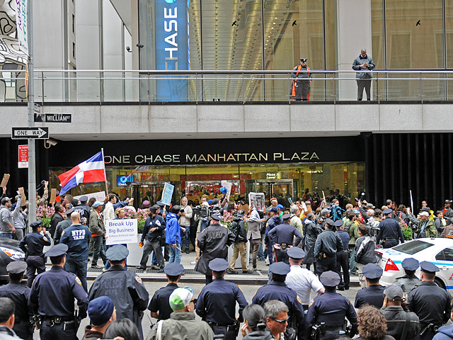 Protesters stop in front of an entrance to One Chase Manhattan Plaza. 