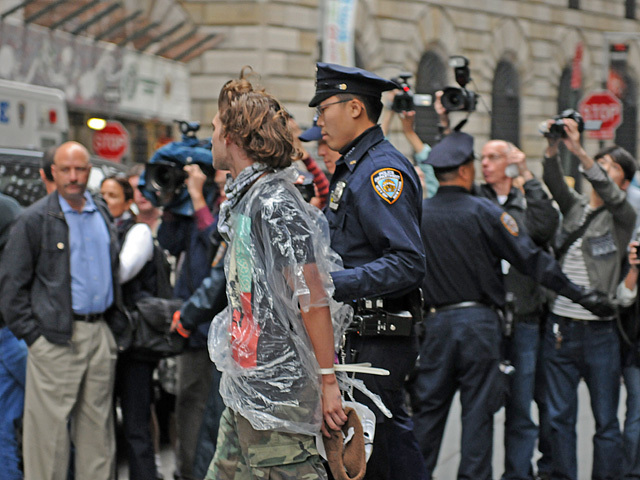 An Occupy Wall Street protester is brought to a police van after being arrested. 