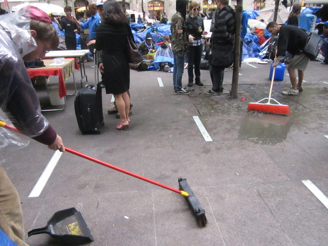 Two protesters cleaned Zuccotti Park Oct. 12, 2011, but neighbors still complain that the plaza is a health hazard. 