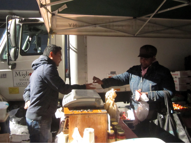 Pasang Dhondup, left, a worker at Migliorelli Farm, said the new West Broadway location is more peaceful but slower than the market's former home in Zuccotti Park. 