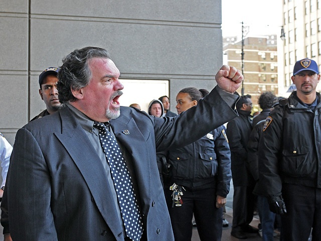 An official with the Patrolmen's Benevolent Association exhorts the crowd outside a Bronx courthouse