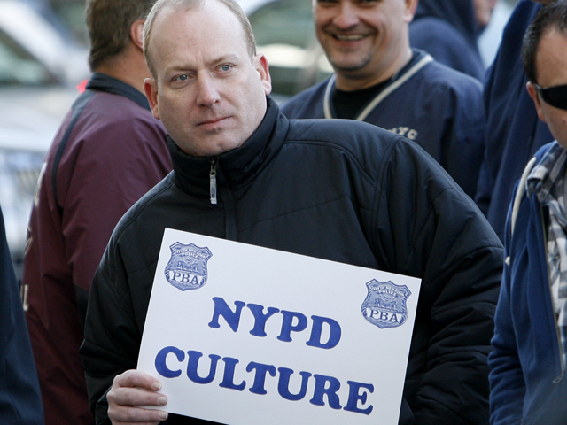 A supporter for the accused NYPD cops involved in ticket fixing scandal outside Bronx Criminal Court Friday morning.