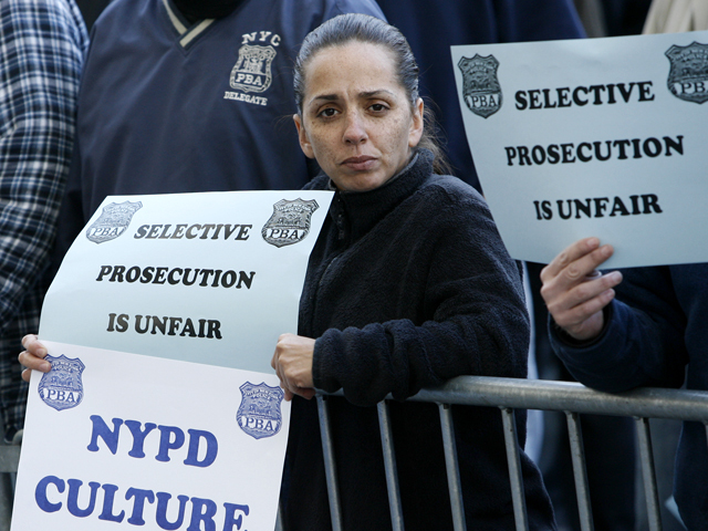 A supporter for the accused NYPD cops involved in ticket fixing scandal outside Bronx Criminal Court Friday.