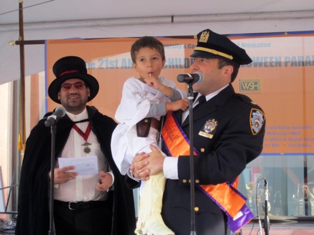 <p>6th Precinct Deputy Inspector Brandon del Pozo with his 4-year-old son, Zane, said the police department would "do its best to deliver a safe and happy Halloween."</p>
