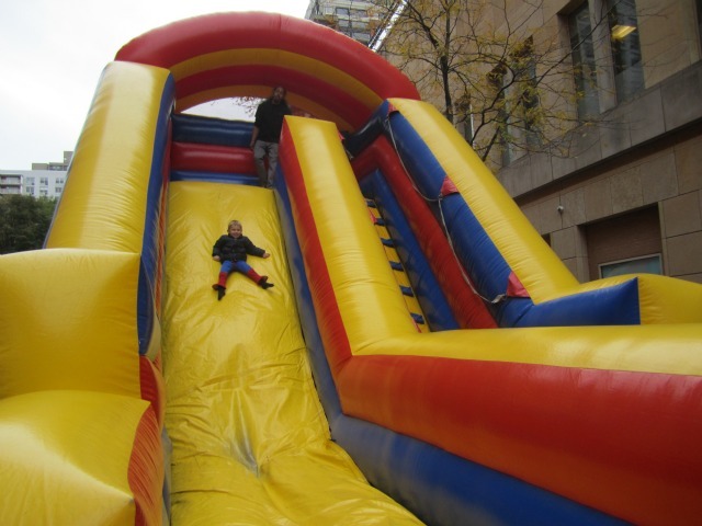 <p>Theo Valente, 3, had fun on the bouncy slide at the Village's Children's Halloween Parade.</p>
