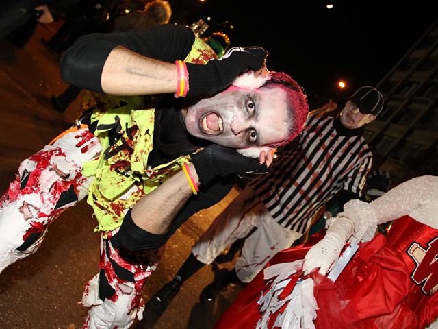 <p>A reveler dressed as a zombie has a thrilling time at the NYC Halloween parade.</p>
