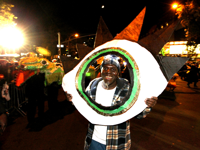 <p>A reveler parades with this year's Halloween theme - an eye based on an 1878 drawing.</p>
