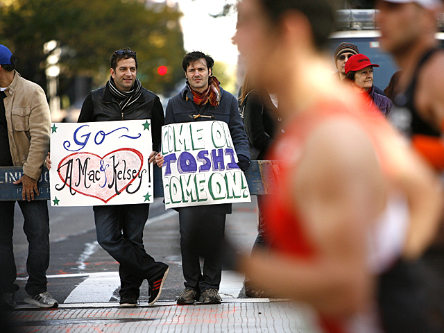 <p>Spectators watch as runners pass by during the New York Marathon.</p>
