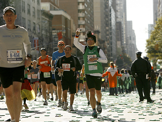 <p>A runner captures another memory during the 2011 NYC Marathon.</p>
