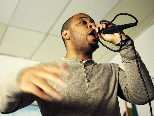 <p>A local rapper performs at the "Word-Up" book store in Washington Heights.</p>

