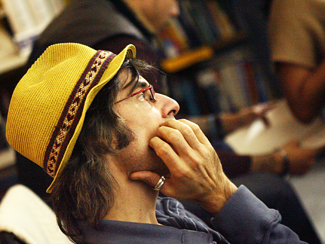 <p>A patron enjoys a poetry readings at Word-Up.</p>
