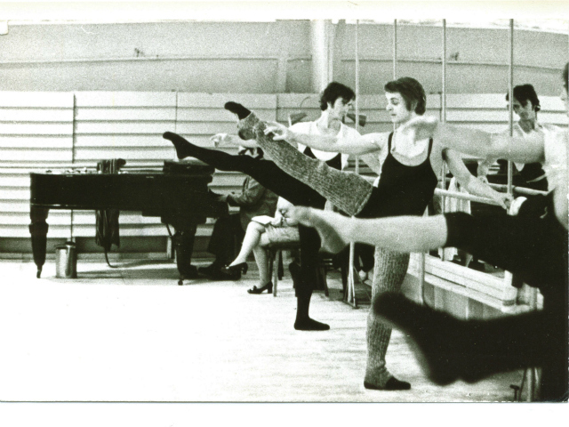 Baryshnikov warms up at the barre.