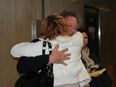 Rayon McIntosh's girlfriend, Althea Bartley, hugs his lawyer, Theodore Herlich, in Manhattan Supreme Court on Dec. 2, 2011 after the charges against McIntosh in the McDonald's beating case were dropped.