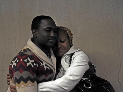 Rayon McIntosh's girlfriend, Althea Bartley (right) hugs his brother-in-law Delmor Wilson in Manhattan Supreme Court on Dec. 2, 2011 after the charges against McIntosh in the McDonald's beating case were dismissed.