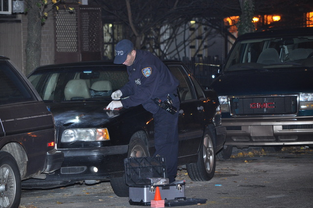 Police investigate a shooting outside 120 W. 94th St. late Sun., Dec. 4, 2011.