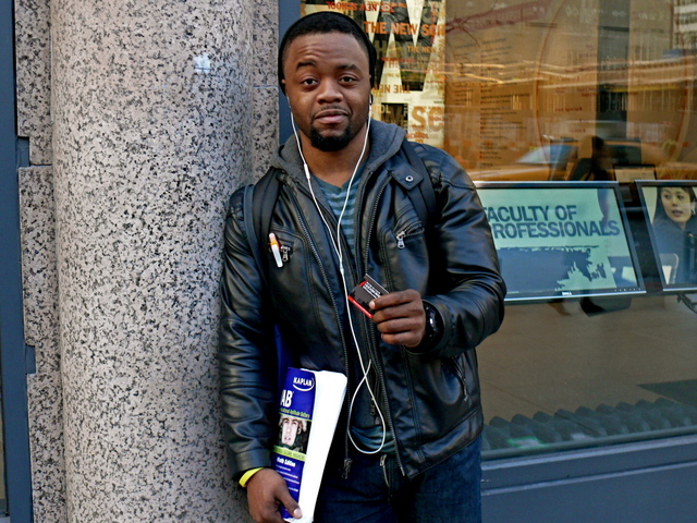 Terrell D. in quilted biker style jacket with hoodie and knitted cap on Fifth Avenue.