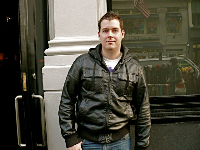 James R. in a bomber style jacket with cropped spiked hair.