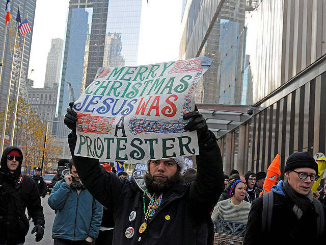 An Occupy Wall Street protester tries to tie in the holidays into his message, Dec. 12, 2011. 