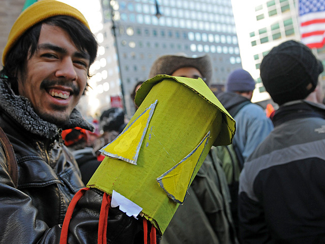 An Occupy Wall Street protesters carries a squid puppet to disparage Goldman Sachs, Dec. 12, 2011. 