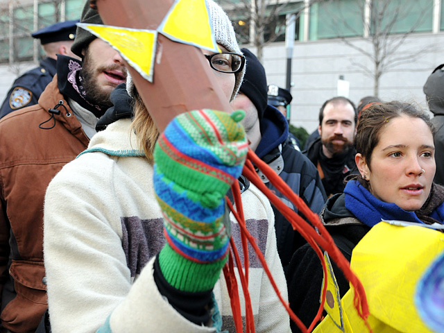A protester peeks out from behind her squid, Dec. 12, 2011. 