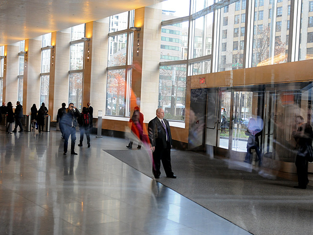 Some workers entering 200 West street stopped to take pictures of the protesters, Dec. 12, 2011. 