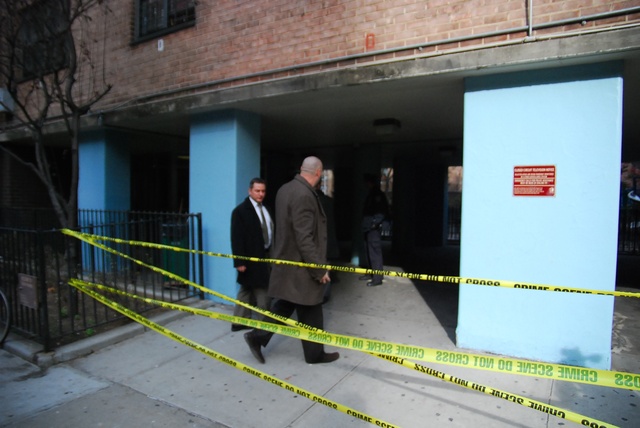 Police officials investigate a shooting and stabbing at the Fulton Houses, next to Chelsea Market.