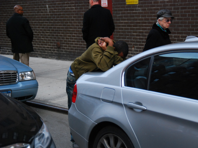 A friend of a victim in a murder-suicide sobs outside the Fulton Houses on Dec. 12, 2011.