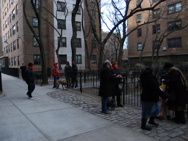 Fulton Houses residents wait for police to allow them back into their apartments.