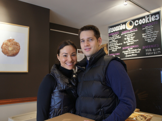 Personal trainers Nedra Lopez and Alex Matosov buy boxes of cookies for friends at Insomnia Cookies' new Upper East Side location.