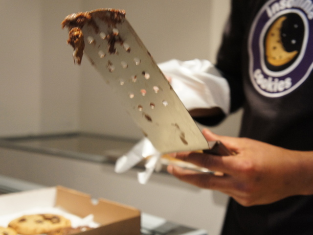Gooey chocolate from a S'mores cookie sticks to the spatula at Insomnia Cookies on the Upper East Side.