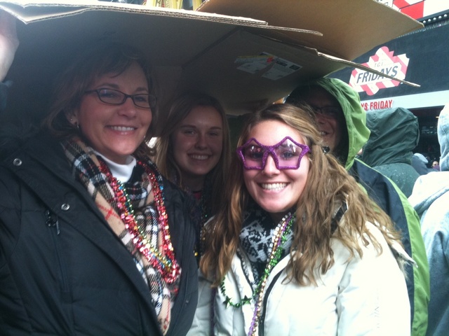 Tanna Wagner (l), Allie Wagner and Kate Gartner, from Redding, Pa, shelter from the rain in Times Square Dec. 31 2011.