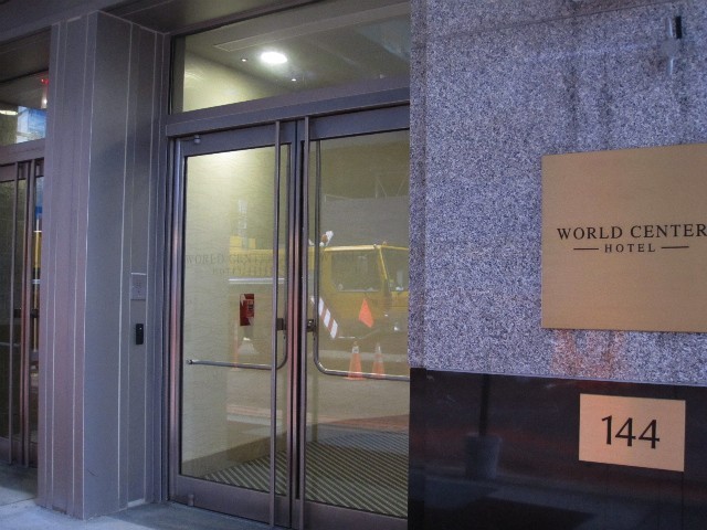 The crane, reflected in the hotel's glass doors.

