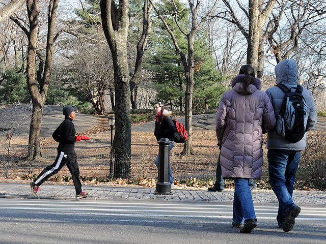A man uses gloves and a hat to keep warm while running through Central Park on Jan. 5, 2012. 