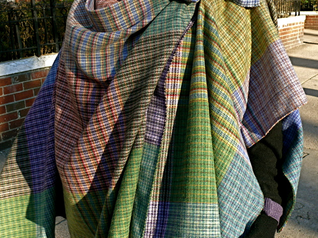 Detail of Diane F. in a colorful, layered draped cape by Vivienne Westwood in Washington Square Park.