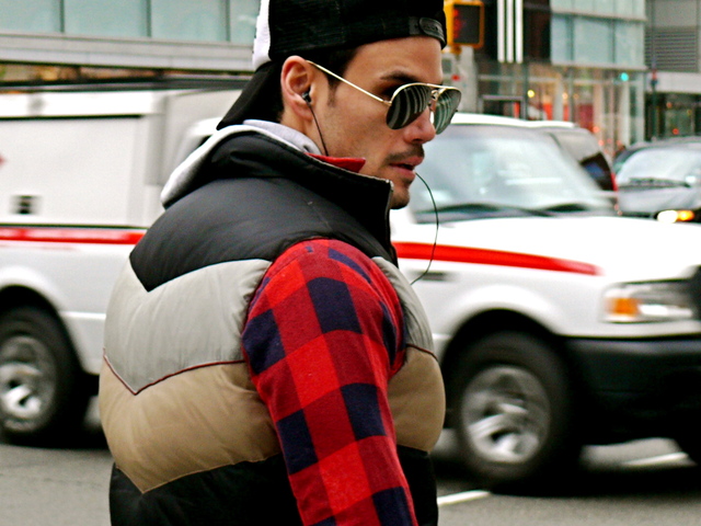 Blue and red buffalo checks with a chevron down vest and southern fried rock baseball cap, on Broadway in SoHo.